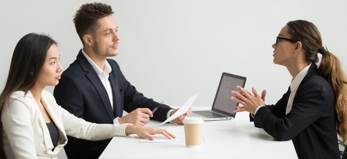 Female job applicant interviewed by two HR managers reading her resume, employee talking about experience, sharing thoughts during recruitment process. Concept of hiring, employment, cooperation